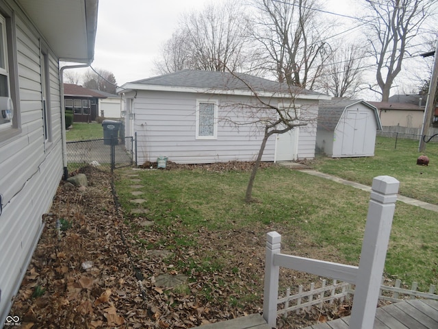 view of yard with fence and an outdoor structure