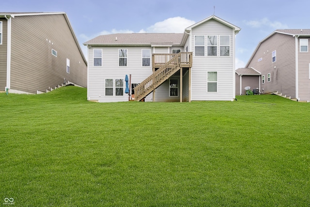 rear view of property with stairs, a lawn, and a wooden deck
