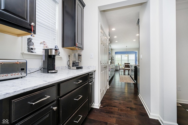 kitchen with a toaster, light stone countertops, baseboards, dark wood-style floors, and recessed lighting