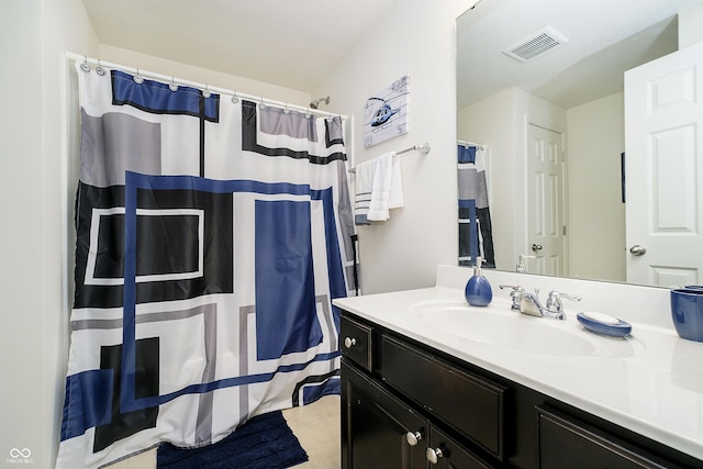 bathroom featuring vanity, curtained shower, and visible vents