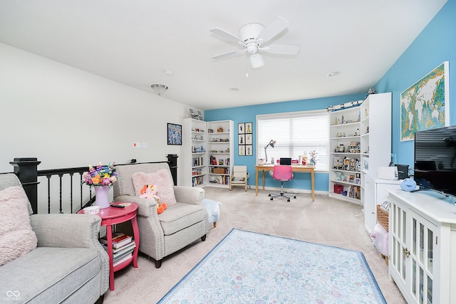 carpeted living room with ceiling fan and baseboards