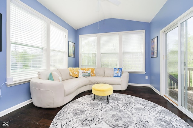 living room with baseboards, lofted ceiling, and a healthy amount of sunlight