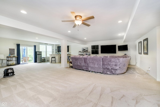 carpeted living room with recessed lighting, a ceiling fan, and baseboards