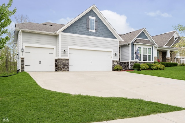 craftsman inspired home with a garage, a front yard, stone siding, roof with shingles, and concrete driveway