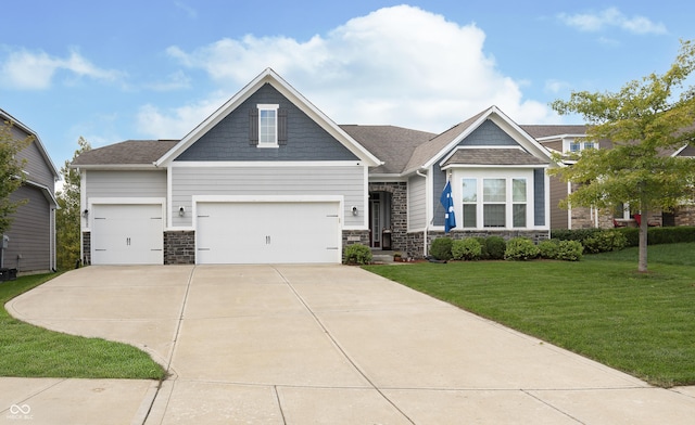 craftsman-style home featuring an attached garage, driveway, a front yard, and stone siding
