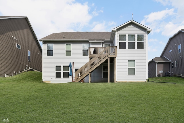 back of house with stairway, a deck, and a yard
