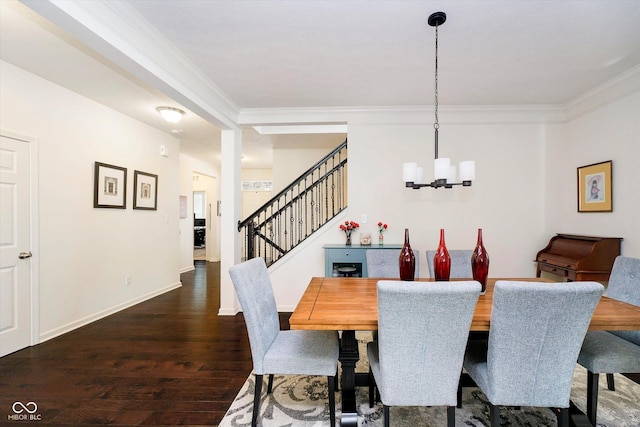 dining room with a chandelier, baseboards, wood finished floors, ornamental molding, and stairway