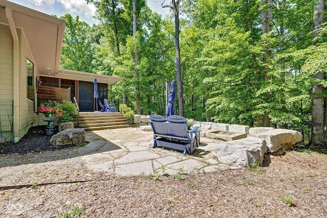 7493 E Rush Ridge Rd, Bloomington, IN 47401 - view of patio / terrace featuring a sunroom and an outdoor fire pit