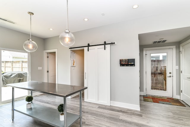 playroom featuring visible vents, a barn door, baseboards, light wood-style floors, and recessed lighting