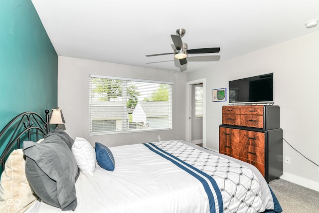 bedroom featuring baseboards, multiple windows, and a ceiling fan