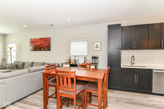 dining room with recessed lighting, light wood-type flooring, wet bar, and visible vents