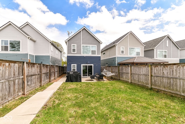 back of house with a yard, a patio, and a fenced backyard