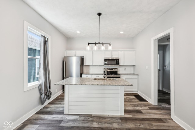 422 N Oxford St, Indianapolis, IN 46201 - kitchen with stainless steel appliances, a center island with sink, tasteful backsplash, white cabinets, and a sink