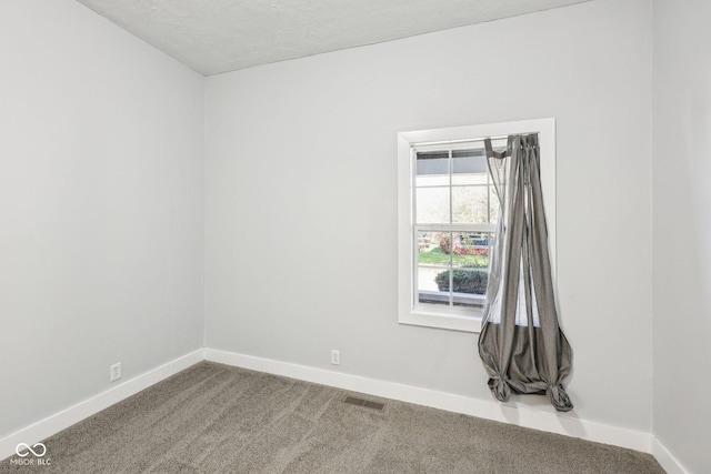 422 N Oxford St, Indianapolis, IN 46201 - spare room featuring baseboards, carpet floors, and a textured ceiling