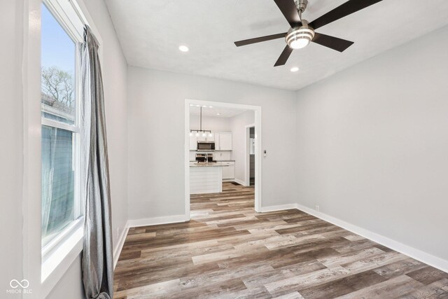 422 N Oxford St, Indianapolis, IN 46201 - unfurnished room with light wood-type flooring, recessed lighting, baseboards, and ceiling fan