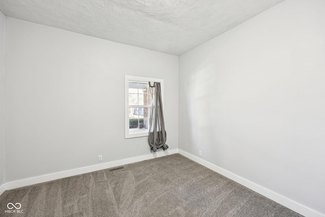 422 N Oxford St, Indianapolis, IN 46201 - unfurnished room with baseboards, carpet flooring, and a textured ceiling