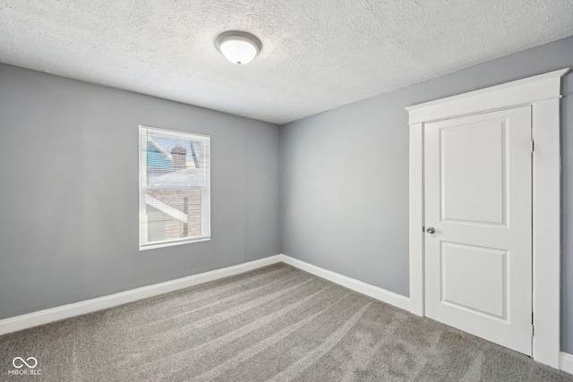 422 N Oxford St, Indianapolis, IN 46201 - carpeted empty room featuring a textured ceiling and baseboards