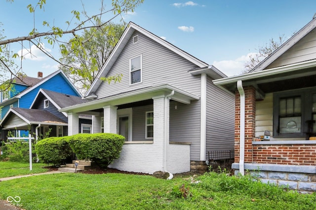 422 N Oxford St, Indianapolis, IN 46201 - view of home's exterior with a yard and brick siding