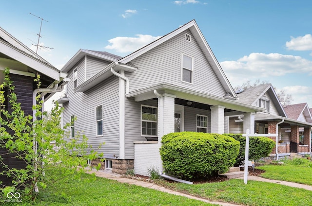 422 N Oxford St, Indianapolis, IN 46201 - view of side of property featuring a porch and a yard