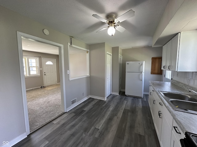 6672 E 225 S, Whitestown, IN 46075 - kitchen featuring ceiling fan, freestanding refrigerator, white cabinetry, visible vents, and a sink