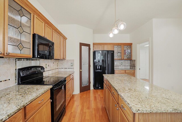 6869 W Winding, Mccordsville, IN 46055 - kitchen featuring glass insert cabinets, black appliances, a center island, light wood finished floors, and decorative backsplash