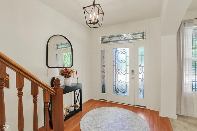 6869 W Winding, Mccordsville, IN 46055 - foyer entrance with a chandelier, stairway, baseboards, and wood finished floors