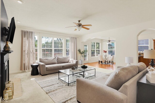 6869 W Winding, Mccordsville, IN 46055 - living area with arched walkways, baseboards, and a ceiling fan