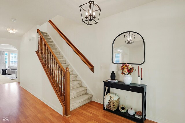 6869 W Winding, Mccordsville, IN 46055 - stairs featuring baseboards, arched walkways, an inviting chandelier, and wood finished floors