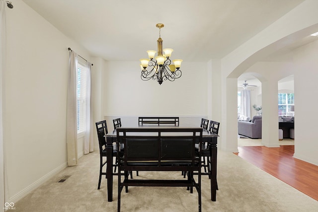 6869 W Winding, Mccordsville, IN 46055 - dining room featuring a wealth of natural light, arched walkways, light carpet, and an inviting chandelier