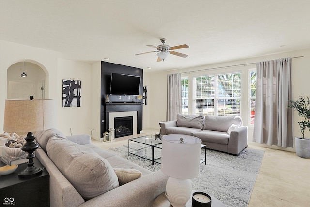 6869 W Winding, Mccordsville, IN 46055 - living area with arched walkways, ceiling fan, a fireplace, and light carpet