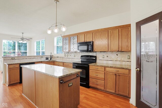 6869 W Winding, Mccordsville, IN 46055 - kitchen featuring a sink, backsplash, black appliances, and light wood-style floors