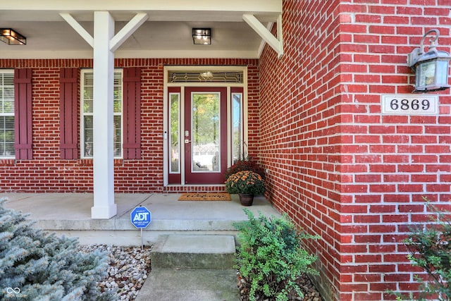 6869 W Winding, Mccordsville, IN 46055 - doorway to property featuring covered porch and brick siding