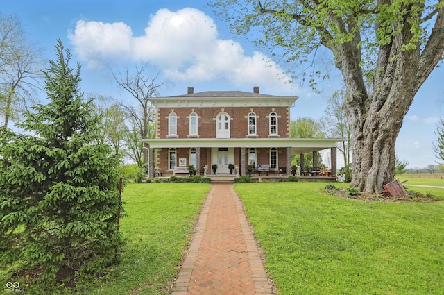 italianate home featuring covered porch, a chimney, a front lawn, and brick siding
