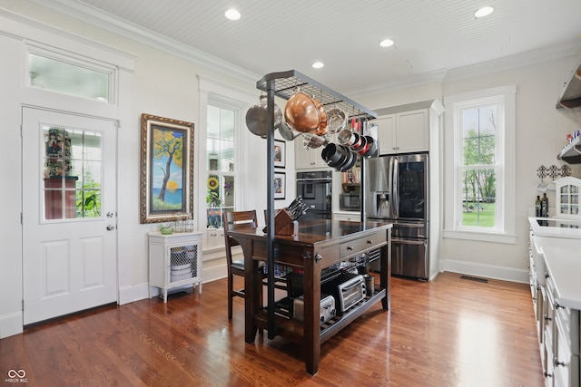 kitchen featuring wood finished floors, baseboards, stainless steel refrigerator with ice dispenser, and recessed lighting