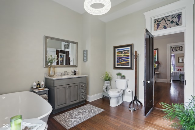 bathroom featuring baseboards, wood finished floors, and a towering ceiling