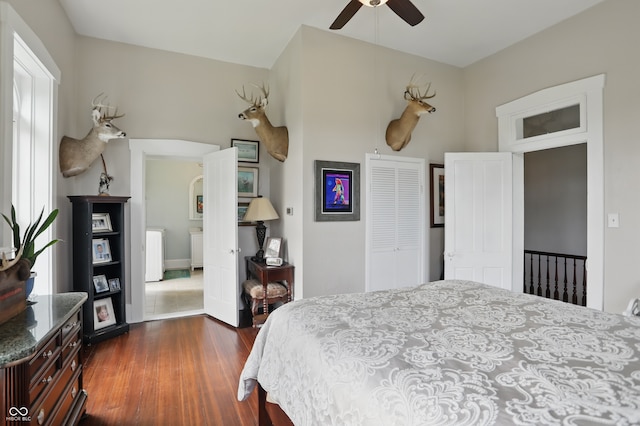 bedroom with dark wood-style flooring, a closet, and ceiling fan