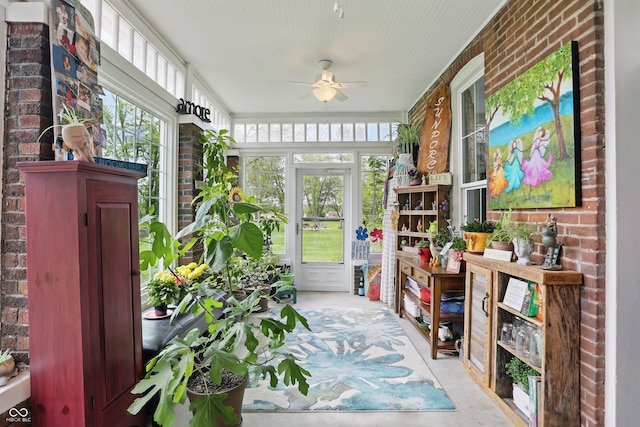 sitting room with brick wall and ceiling fan