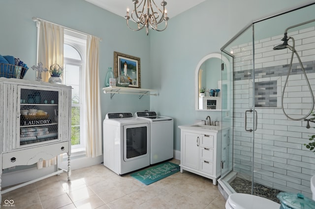bathroom with vanity, tile patterned floors, washer and dryer, an inviting chandelier, and a shower stall