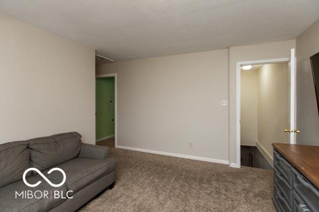 5973 Masten Rd, Coatesville, IN 46121 - carpeted living area featuring baseboards and a textured ceiling