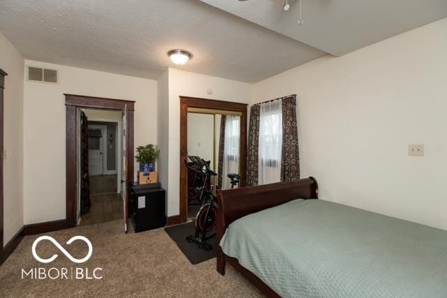 5973 Masten Rd, Coatesville, IN 46121 - carpeted bedroom with visible vents, a ceiling fan, a closet, and a textured ceiling