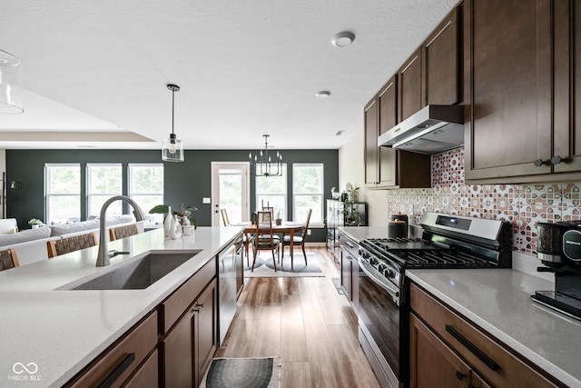 1024 Cyprian Way, Lebanon, IN 46052 - kitchen with appliances with stainless steel finishes, extractor fan, a sink, light wood-style flooring, and pendant lighting