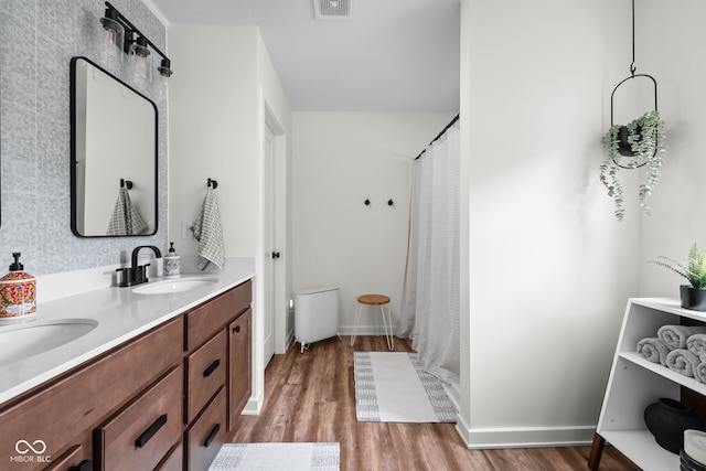 1024 Cyprian Way, Lebanon, IN 46052 - bathroom featuring double vanity, wood finished floors, and curtained shower