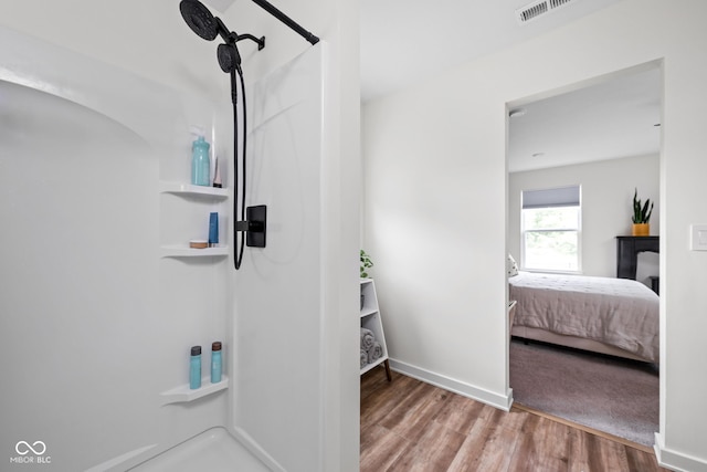 1024 Cyprian Way, Lebanon, IN 46052 - ensuite bathroom featuring a shower, wood finished floors, and baseboards