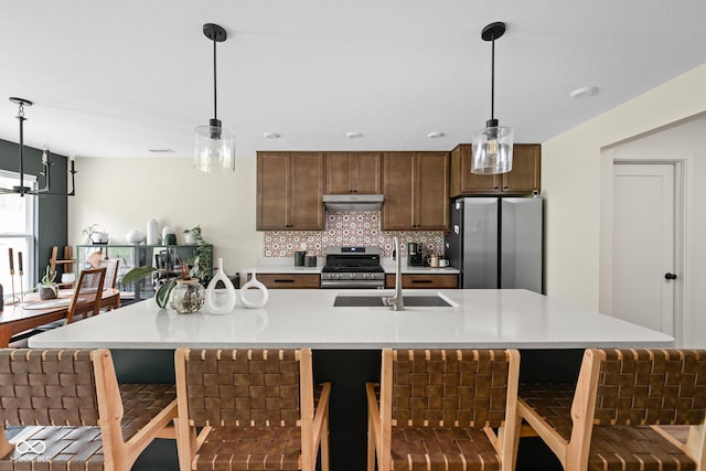 1024 Cyprian Way, Lebanon, IN 46052 - kitchen with stainless steel appliances, light countertops, under cabinet range hood, and a sink