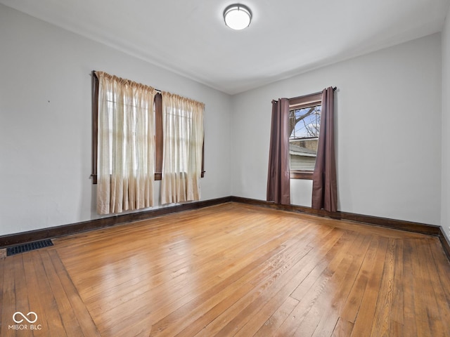 270 W Broadway St, Shelbyville, IN 46176 - empty room featuring baseboards, visible vents, and hardwood / wood-style flooring