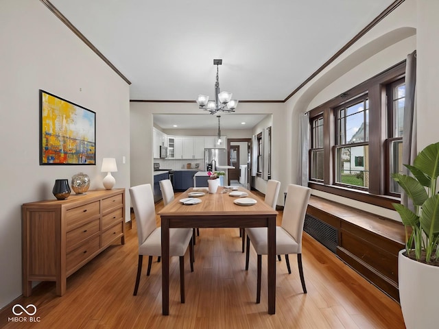 270 W Broadway St, Shelbyville, IN 46176 - dining room with light wood-type flooring, a notable chandelier, and ornamental molding