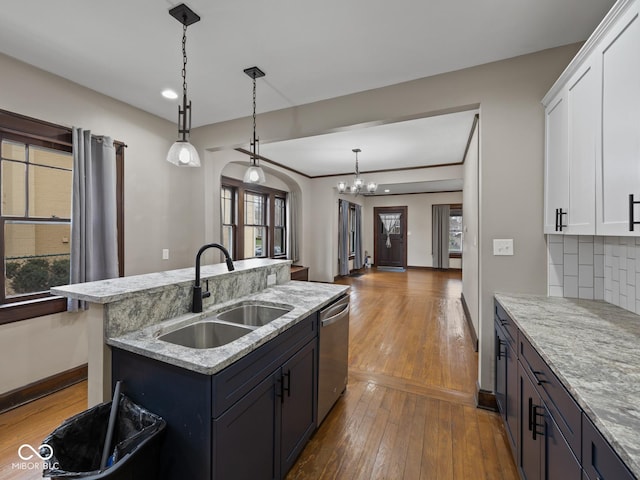270 W Broadway St, Shelbyville, IN 46176 - kitchen featuring a sink, a chandelier, stainless steel dishwasher, dark wood-style floors, and arched walkways