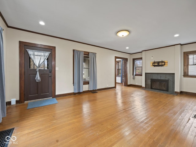 270 W Broadway St, Shelbyville, IN 46176 - unfurnished living room with crown molding, baseboards, a fireplace, and light wood-type flooring