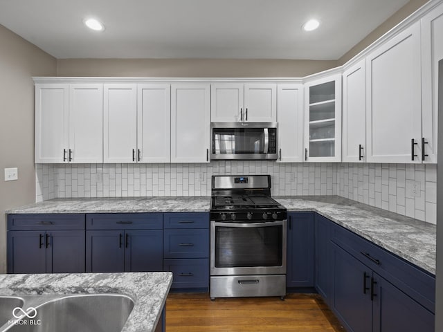 270 W Broadway St, Shelbyville, IN 46176 - kitchen featuring white cabinets, blue cabinetry, and stainless steel appliances