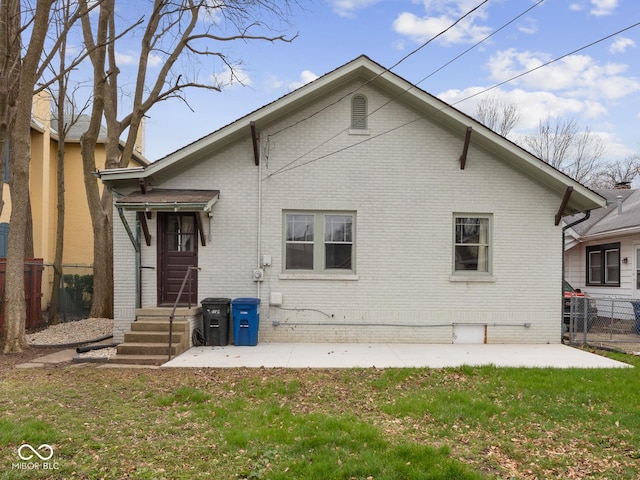 270 W Broadway St, Shelbyville, IN 46176 - back of house featuring a lawn, brick siding, and fence